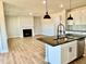 Living room with a fireplace, island and pendant lights, and an open concept kitchen at 22 Whistling Way # Holly Farmhouse, Lillington, NC 27546
