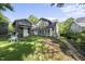 Backyard of a classic home with a detached garage and a sunroom at 230 E Park Dr, Raleigh, NC 27605