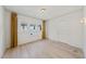 Spacious bedroom with light wood floors, natural light, and a closet door at 230 E Park Dr, Raleigh, NC 27605