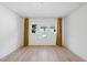 Spacious bedroom with light wood floors, and three windows with curtains at 230 E Park Dr, Raleigh, NC 27605