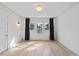 Bedroom with a ceiling fan, hardwood floors, large window, and dark curtains at 230 E Park Dr, Raleigh, NC 27605