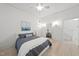 Bright bedroom with a ceiling fan, art, ensuite access, and hardwood flooring at 230 E Park Dr, Raleigh, NC 27605