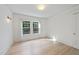 Bright bedroom featuring light wood floors, white walls and ceiling, and a window at 230 E Park Dr, Raleigh, NC 27605