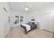 Light bedroom with a window seat, built-in storage, ceiling fan, and hardwood flooring at 230 E Park Dr, Raleigh, NC 27605
