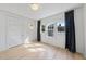 Bright bedroom with natural light, white walls, light wood floors, and neutral drapes at 230 E Park Dr, Raleigh, NC 27605