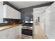 Stylish kitchen with new stainless steel appliances and modern backsplash at 230 E Park Dr, Raleigh, NC 27605