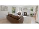 Cozy living room featuring a fireplace and natural light from large windows at 230 E Park Dr, Raleigh, NC 27605