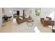 Open-concept living area with a leather sofa, large windows, and a light-colored rug at 230 E Park Dr, Raleigh, NC 27605