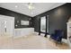 Living room with hardwood floors, built-in cabinets, and a large window with black curtains at 230 E Park Dr, Raleigh, NC 27605