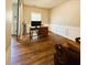 Well-lit room boasts hardwood floors, decorative trim, and a sliding barn door for added charm at 2317 Rainy Lake St, Wake Forest, NC 27587