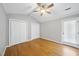 Bedroom with hardwood floors, neutral walls, and a ceiling fan at 300 W Woodcroft Pkwy # 28D, Durham, NC 27713