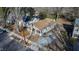 Aerial view of a home with charming porch and a spacious lot surrounded by mature trees and neighborhood streets at 306 N Driver St, Durham, NC 27703