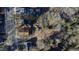 Drone shot of a suburban backyard with mature trees, sheds and a boat at 306 N Driver St, Durham, NC 27703