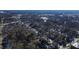 An aerial view of a neighborhood featuring tree-lined streets and commercial building in the distance at 306 N Driver St, Durham, NC 27703
