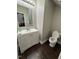 Cozy half-bath with wood floors, a single sink vanity, and modern fixtures at 3144 La Costa Way, Raleigh, NC 27610