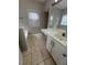 Bright bathroom featuring double sink vanity, tile floors, and a large mirror at 3144 La Costa Way, Raleigh, NC 27610