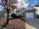Charming two-story home with stone accents, attached garage, and tree-lined front yard at 3144 La Costa Way, Raleigh, NC 27610