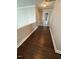 Hallway with dark wood floors leading to bathroom at 3144 La Costa Way, Raleigh, NC 27610