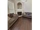 Comfortable living area with a cozy fireplace, built-in shelving, and plush couches at 3144 La Costa Way, Raleigh, NC 27610