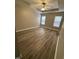 Tranquil main bedroom featuring a tray ceiling, ceiling fan, and natural light from two windows at 3144 La Costa Way, Raleigh, NC 27610