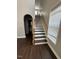 Bright staircase with wooden handrail and dark wood floors at 3144 La Costa Way, Raleigh, NC 27610