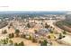 Neighborhood aerial view featuring homes, golf course, trees, and a community pool at 325 Sandy Ridge Rd, Dunn, NC 28334