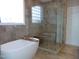 Bathroom featuring a modern bathtub with a tray and glass enclosed shower at 325 Sandy Ridge Rd, Dunn, NC 28334