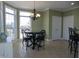 Sunlit breakfast nook features a chandelier, bay window, and round table with decorative chairs at 325 Sandy Ridge Rd, Dunn, NC 28334