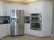 Modern kitchen with stainless steel appliances and white cabinetry at 325 Sandy Ridge Rd, Dunn, NC 28334