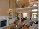 Spacious living room featuring a fireplace, built-in shelving, hardwood floors, and a view into the dining room at 325 Sandy Ridge Rd, Dunn, NC 28334