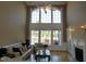 Living room with vaulted ceilings, large windows, and fireplace at 325 Sandy Ridge Rd, Dunn, NC 28334