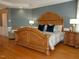 Large primary bedroom with hardwood floors and a decorative bed frame at 325 Sandy Ridge Rd, Dunn, NC 28334