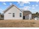 The home's back exterior shows the home's siding, windows, and covered patio at 366 Tormore Dr, Sanford, NC 27330