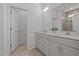 Elegant bathroom with double sinks and a tiled walk-in shower with glass door at 366 Tormore Dr, Sanford, NC 27330