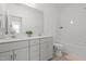 Bright bathroom featuring a double sink vanity with quartz countertop and vinyl wood flooring at 366 Tormore Dr, Sanford, NC 27330