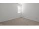 Clean and simple bedroom with wall-to-wall carpet flooring and a large window with blinds at 366 Tormore Dr, Sanford, NC 27330