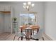 Cozy dining area with a round table, modern chairs, and large windows offering backyard views at 366 Tormore Dr, Sanford, NC 27330