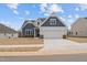 Charming two-story home with blue and white accents, a two-car garage, and a well-maintained lawn at 366 Tormore Dr, Sanford, NC 27330