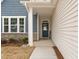 Inviting entryway with a stylish blue door, stone accents, and ample natural light at 366 Tormore Dr, Sanford, NC 27330