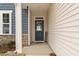Inviting entryway with a stylish blue door, stone accents, and ample natural light at 366 Tormore Dr, Sanford, NC 27330