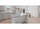 Well-lit kitchen with granite countertops, stainless appliances, an island, and a view to the dining area at 366 Tormore Dr, Sanford, NC 27330