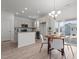 Open kitchen and dining area with stainless steel appliances, granite countertops, and modern finishes at 366 Tormore Dr, Sanford, NC 27330