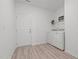 Convenient laundry room with wood-look vinyl flooring and an included washer and dryer at 366 Tormore Dr, Sanford, NC 27330