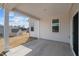 Covered patio area with concrete floor and white support columns, perfect for outdoor relaxation at 366 Tormore Dr, Sanford, NC 27330