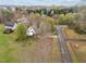 Scenic aerial view of a home nestled among trees, showcasing its spacious lot and neighborhood at 3738 Lindsey Woods Rd, Hillsborough, NC 27278