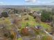 An elevated perspective of the property showcasing the house, surrounding trees, and neighborhood at 3738 Lindsey Woods Rd, Hillsborough, NC 27278