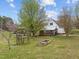 Expansive backyard featuring a playset and wooden raised garden beds at 3738 Lindsey Woods Rd, Hillsborough, NC 27278