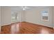 Bright bedroom features laminate flooring, a ceiling fan, and multiple windows offering abundant natural light at 3738 Lindsey Woods Rd, Hillsborough, NC 27278