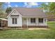 Attractive single-Gathering home featuring a front porch with white railing and blue shutters at 3738 Lindsey Woods Rd, Hillsborough, NC 27278
