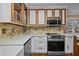 Well-appointed kitchen featuring custom cabinetry, granite countertops, and stainless steel appliances for modern living at 3738 Lindsey Woods Rd, Hillsborough, NC 27278